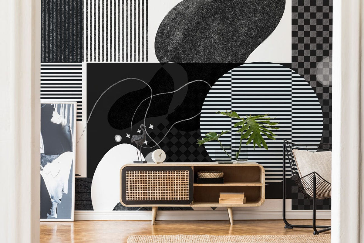 Monochrome geometric art wallpaper in modern living room with wooden flooring, natural cabinet, and chair.