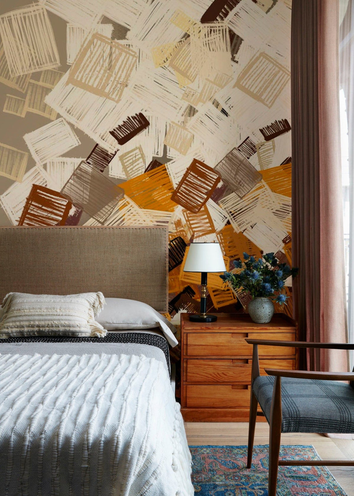 Geometric Abstract Autumn Squares Wallpaper, rustic browns, ochre tones in bedroom with wooden furniture, armchair.