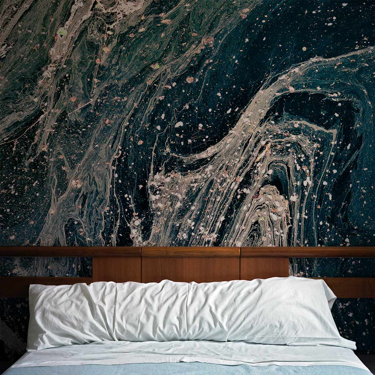 Deep Ocean Marble Swirl Abstract Mural Wallpaper with bed in modern bedroom, contrasting teal-blue design.