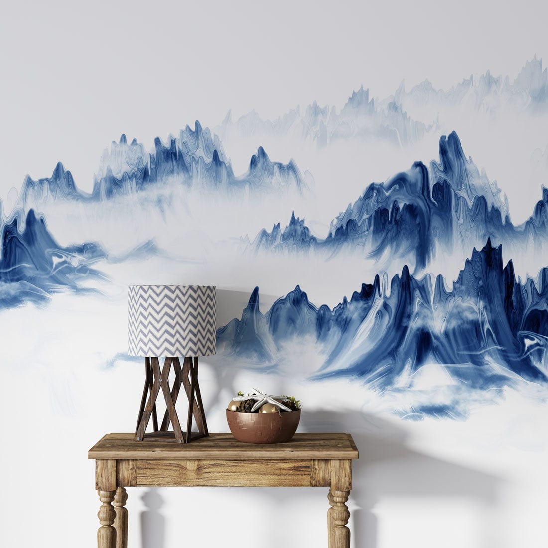 Serene Blue Mountain Mist Mural Wallpaper with rustic wood console table and chevron lamp.