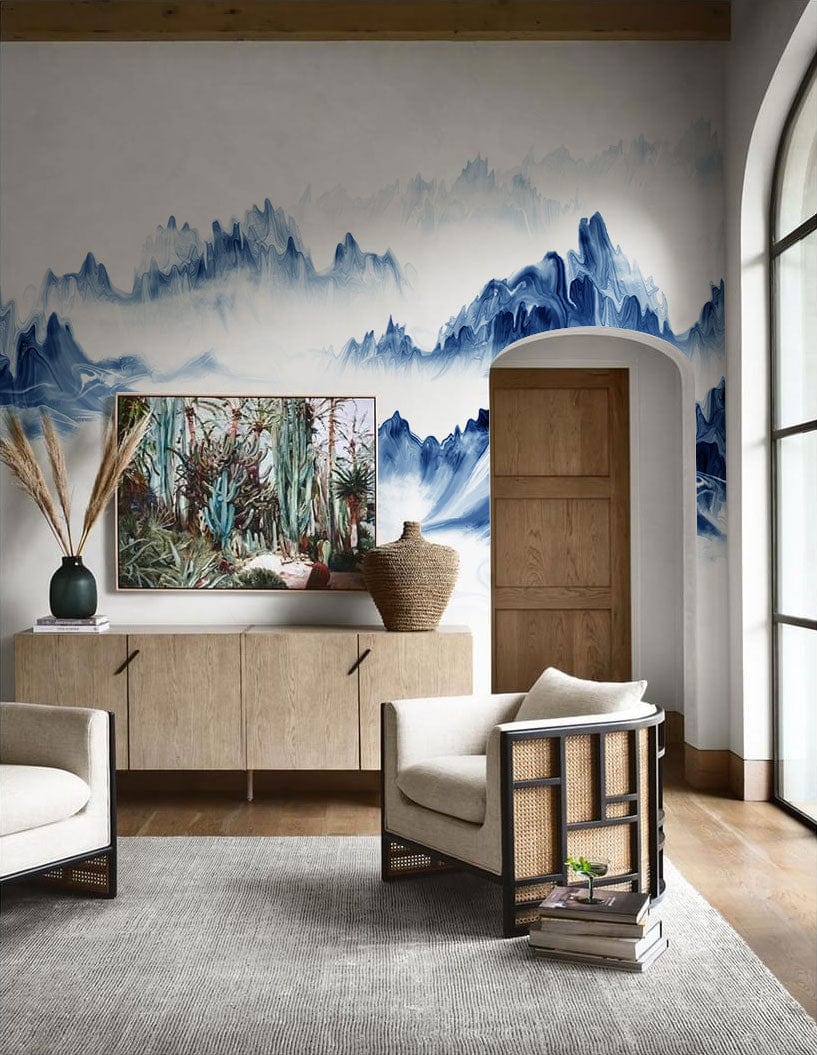 Serene Blue Mountain Mist Mural Wallpaper in living room with grey rug, beige armchairs, wooden flooring.