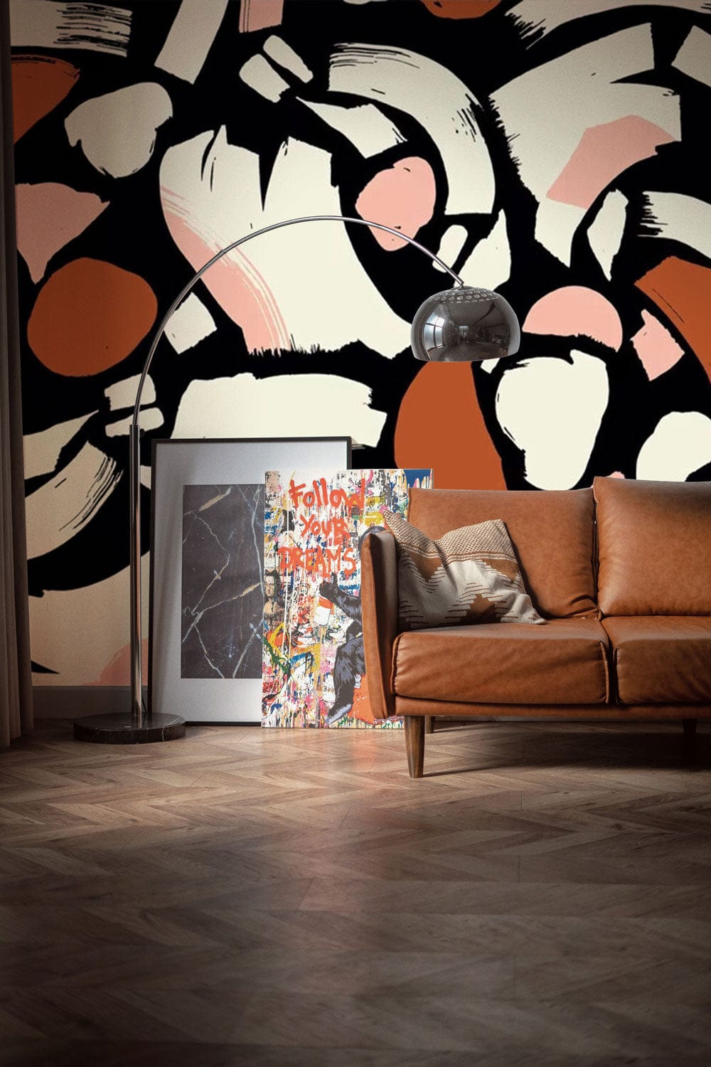 Abstract geometric wallpaper with brown leather sofa, wooden flooring, in modern living room setting.