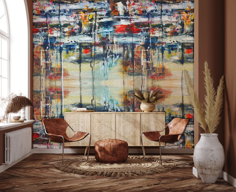 Vibrant abstract mural behind brown leather chairs, bohemian decor, and wooden flooring in living room.