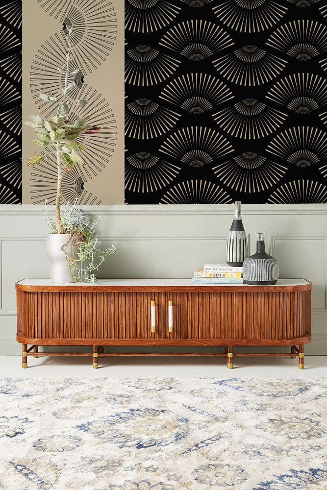 Art Deco fan pattern wallpaper with wooden sideboard, stylish carpet, and grey panelled wall.