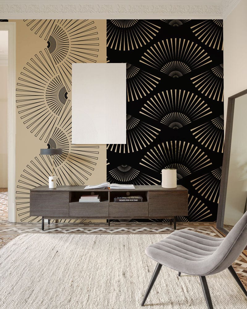Art Deco wallpaper with black-gold fan pattern in stylish living room; featuring grey chair, sideboard.