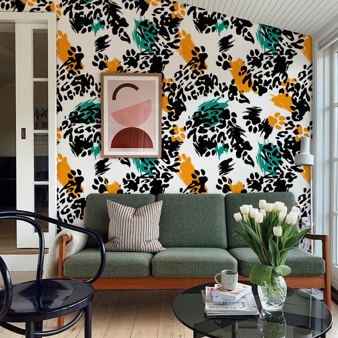 Bold abstract wallpaper in vibrant colours, complements green sofa, wooden floor, and stylish decor.