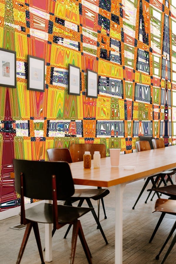 Vibrant geometric mural wallpaper with colourful pattern in modern dining room, wooden table, dark chairs.