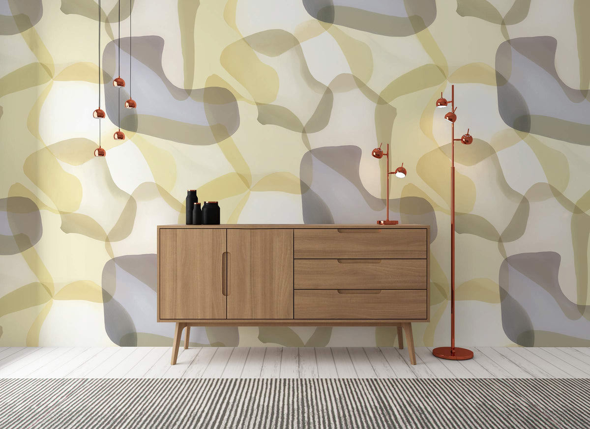 Abstract pastel geometric wallpaper in cream, grey tones; mid-century cabinet, red lamps, wood flooring.