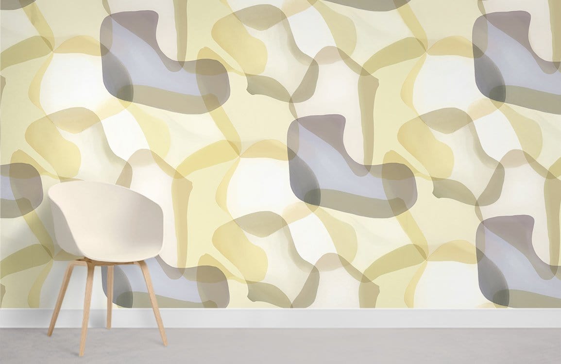 Abstract pastel geometric wallpaper in cream and grey tones behind a modern white chair, grey flooring.