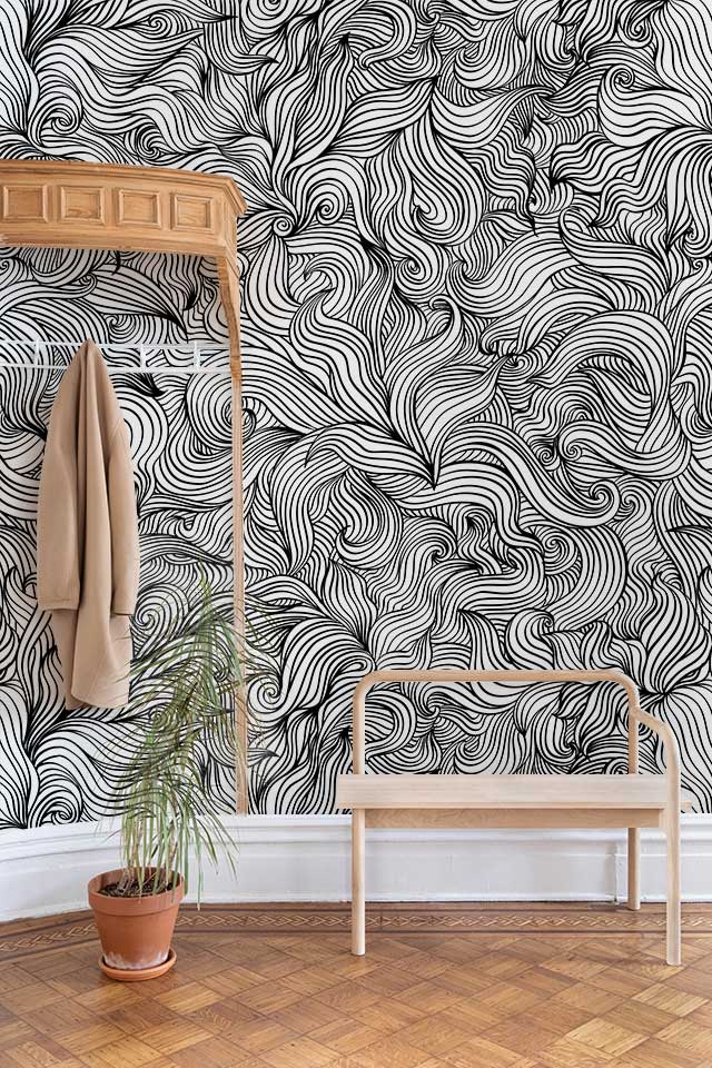 Monochrome abstract lines wall art, wooden bench, parquet flooring, and coat rack in stylish room.