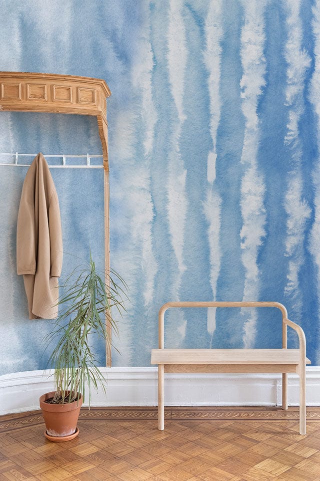 Watercolour Ocean Ripple Effect blue wall mural with wooden bench, parquet flooring, and coat rack.