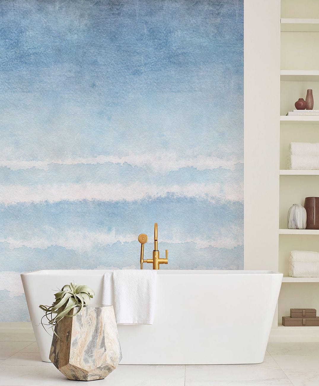 Tranquil Blue Watercolour Ombre Wall Mural, white bathtub, beige wall shelves, serene bathroom design.