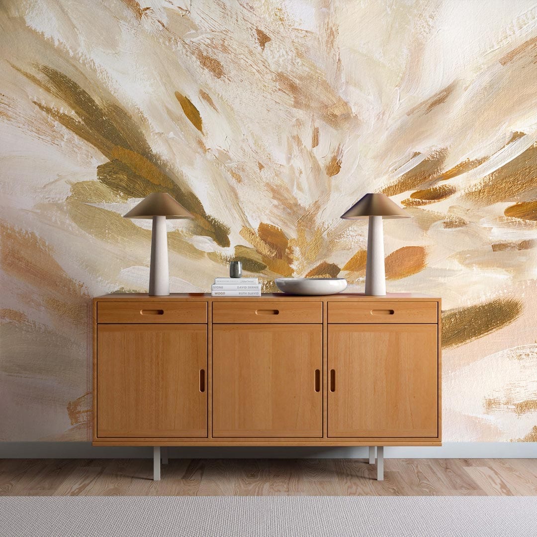 Abstract mural wallpaper with beige, brown, olive; mid-century sideboard, wood flooring, table lamps, decorative bowls.