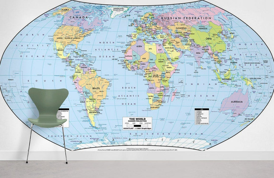 Vintage World Map Mural Wallpaper with modern chair on grey flooring in minimalist room setting.