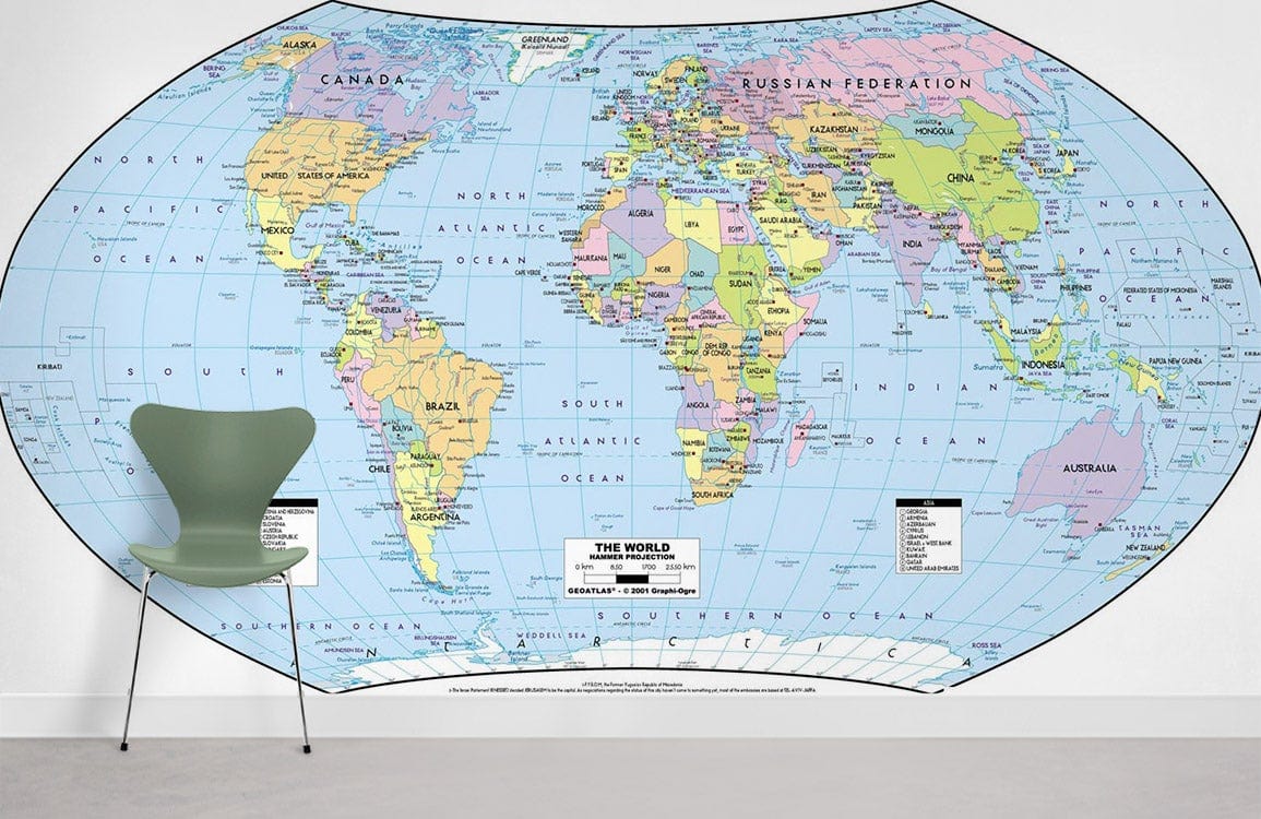 Vintage World Map Mural Wallpaper with modern chair on grey flooring in minimalist room setting.