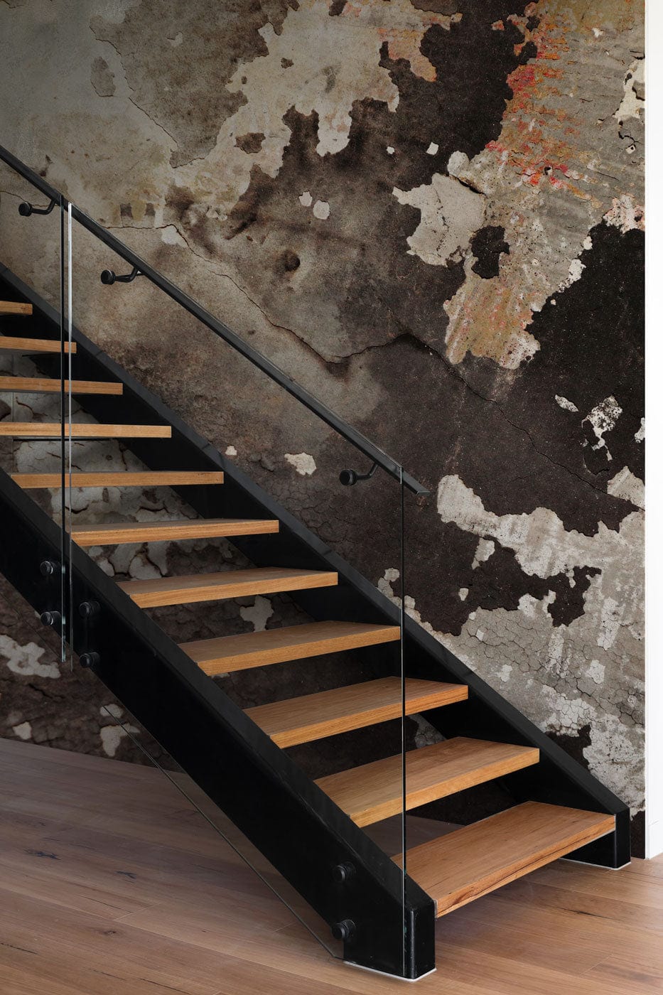 Vintage Grunge Textured Abstract Wallpaper and wooden staircase in modern hallway with earthy tones.