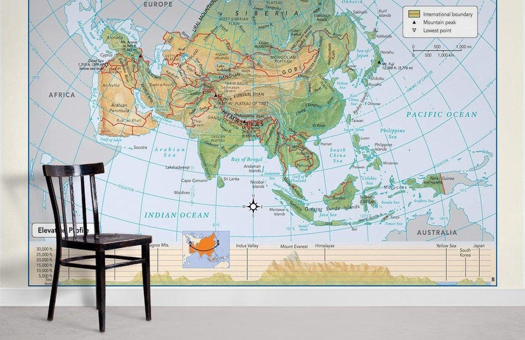 Vintage Asia Pacific map mural wallpaper in earthy tones, minimalist study with wooden chair and flooring.