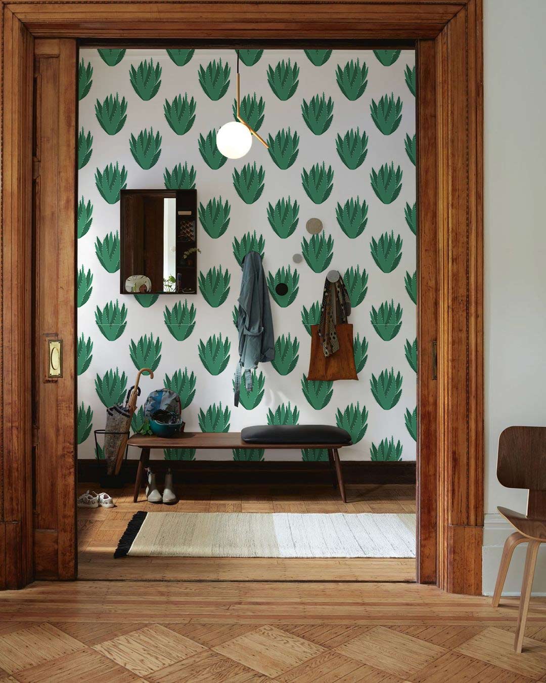 Fresh Green Leaf Pattern Wallpaper with wooden decor, bench, pendant light, and parquet flooring in hallway.