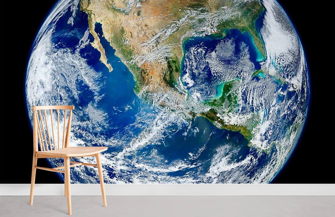 Earth from Space Mural Wallpaper, blue-green planet design, wooden chair, grey flooring, modern setting.