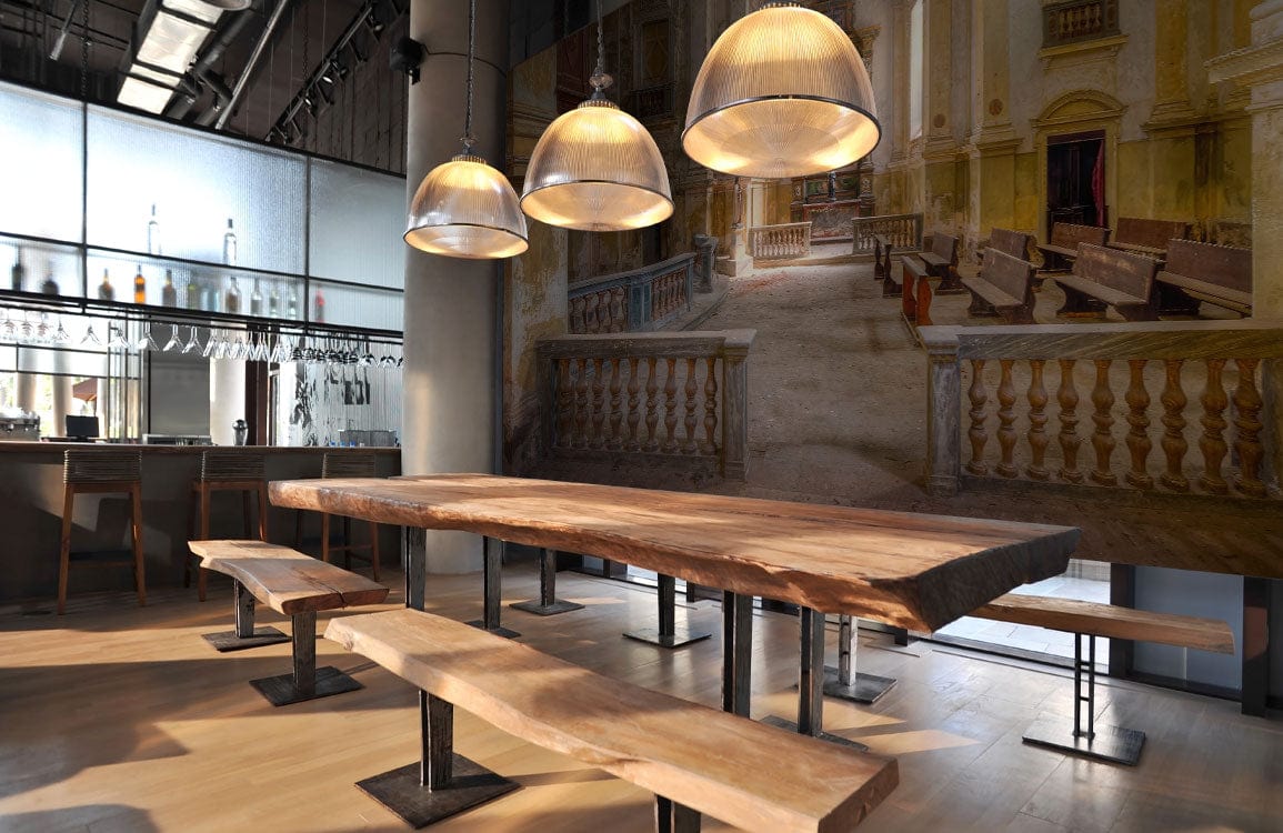 Vintage European Abbey mural in warm tones, modern dining room with wooden benches, industrial lighting.