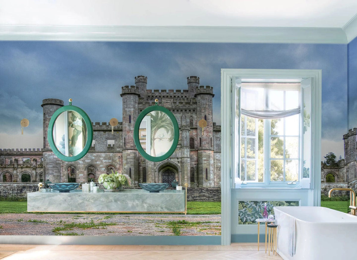 Majestic Stone Castle Mural Wallpaper, moody grey-green tones, blue walls, luxurious bathtub, ornate mirrors.