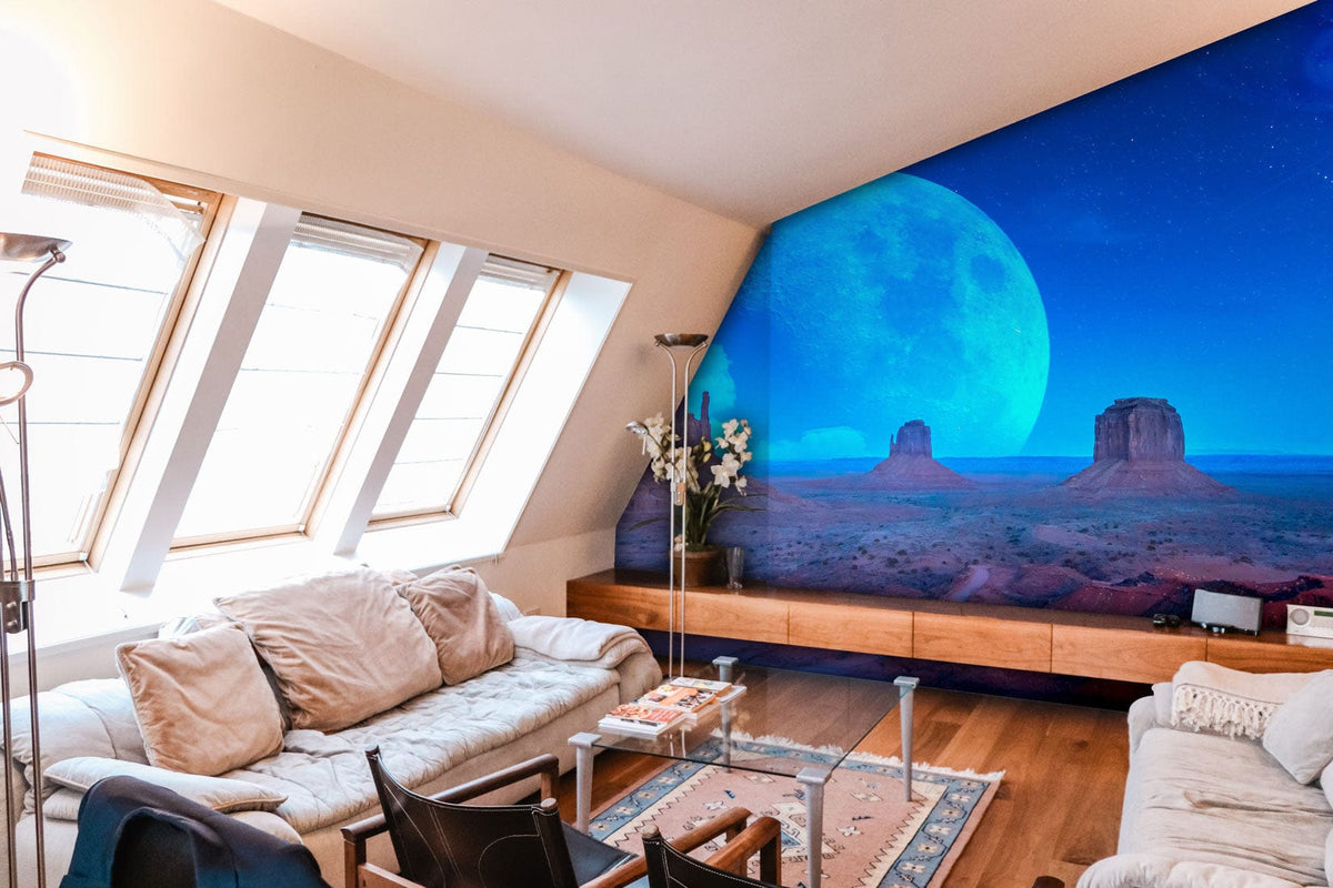 Surreal desert moonlit mural in blue tones, modern living room, beige sofas, wooden flooring.