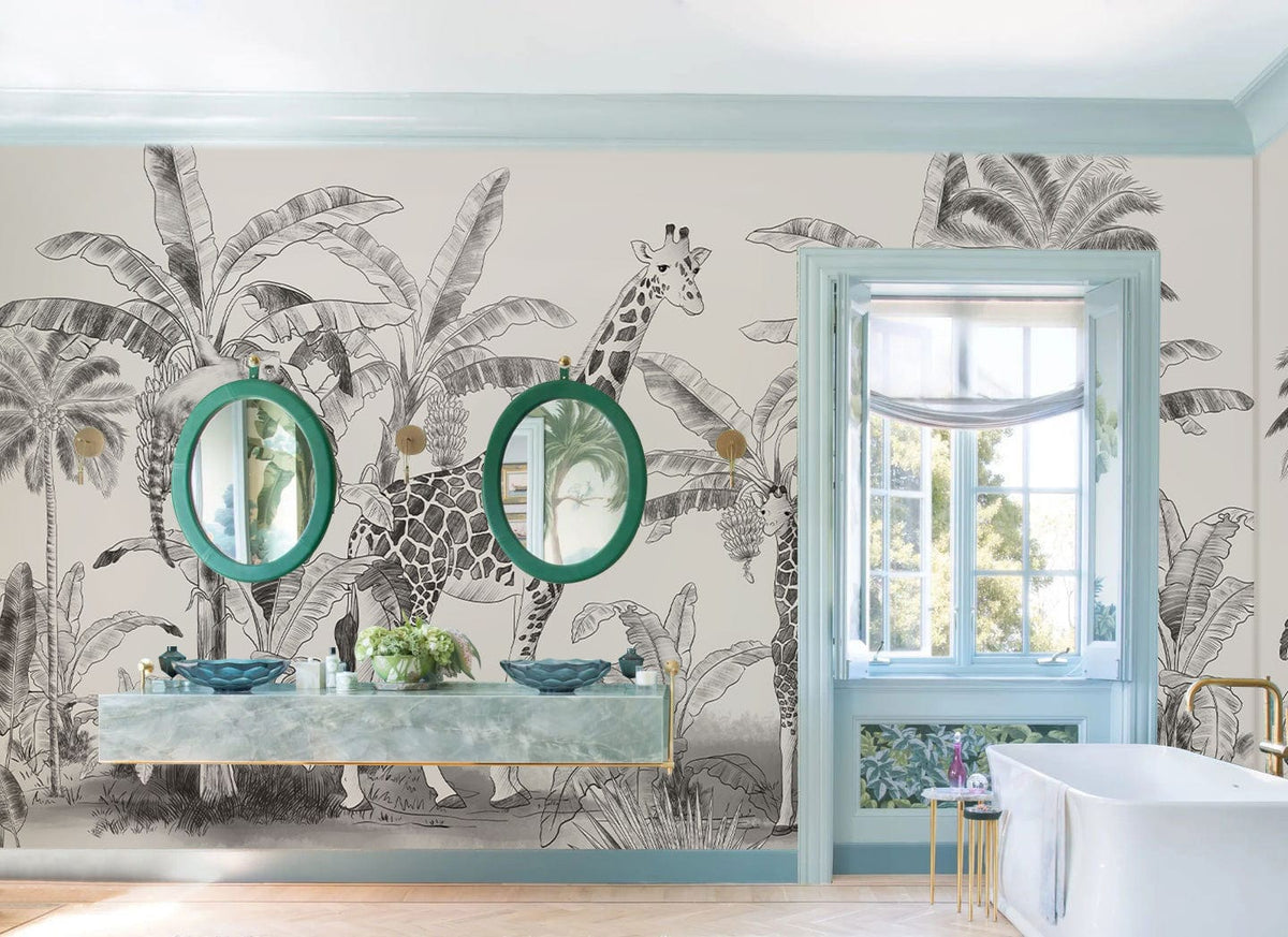 Monochrome safari mural wallpaper with giraffes, palms in bathroom; features turquoise mirrors and marble countertop.