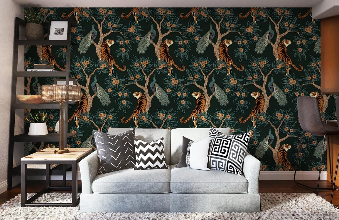 Tropical jungle mural wallpaper with tigers, peacocks, grey sofa, dark bookshelf, and wooden flooring.