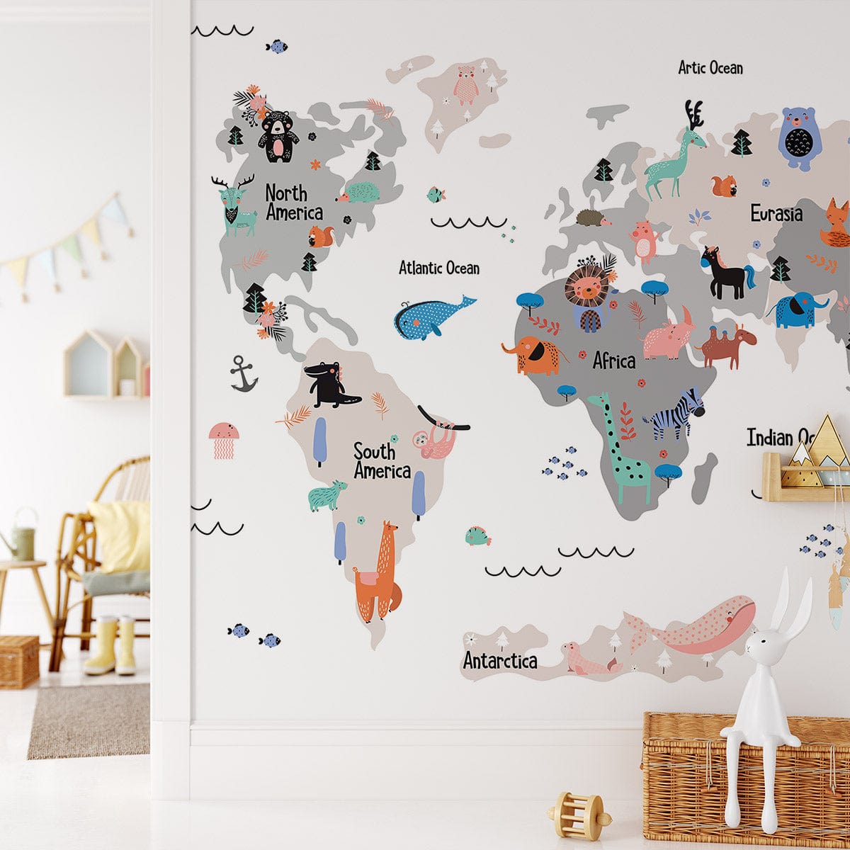 Children's colourful world map mural wallpaper featuring animals, wooden chair, and woven basket in kids' room.
