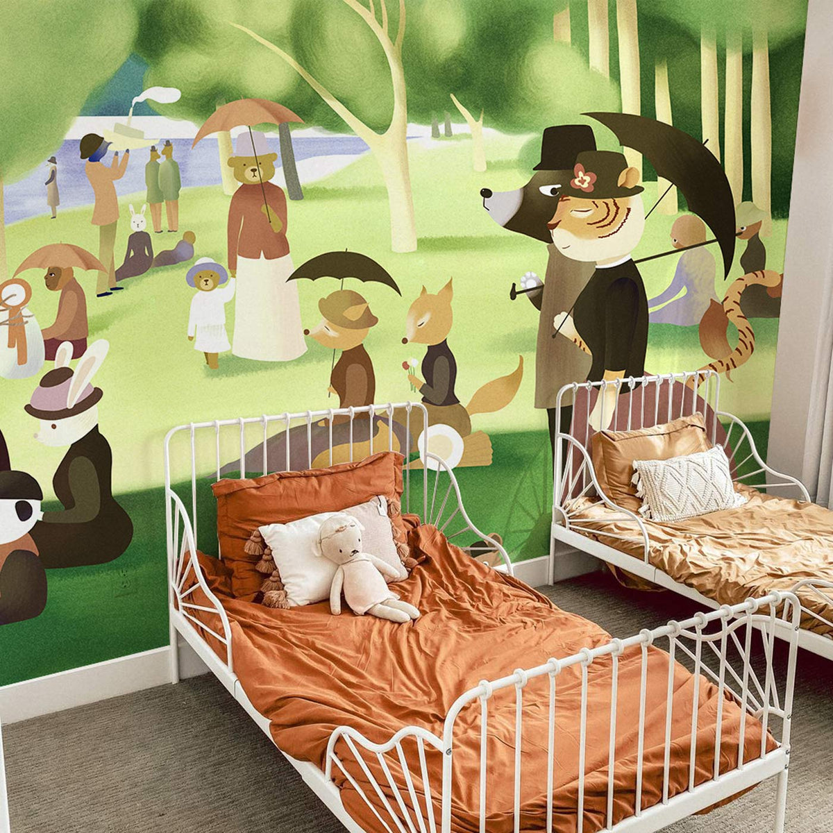 Children's bedroom with Vintage Animal Parade mural, white metal beds, orange bedding, grey carpet flooring.