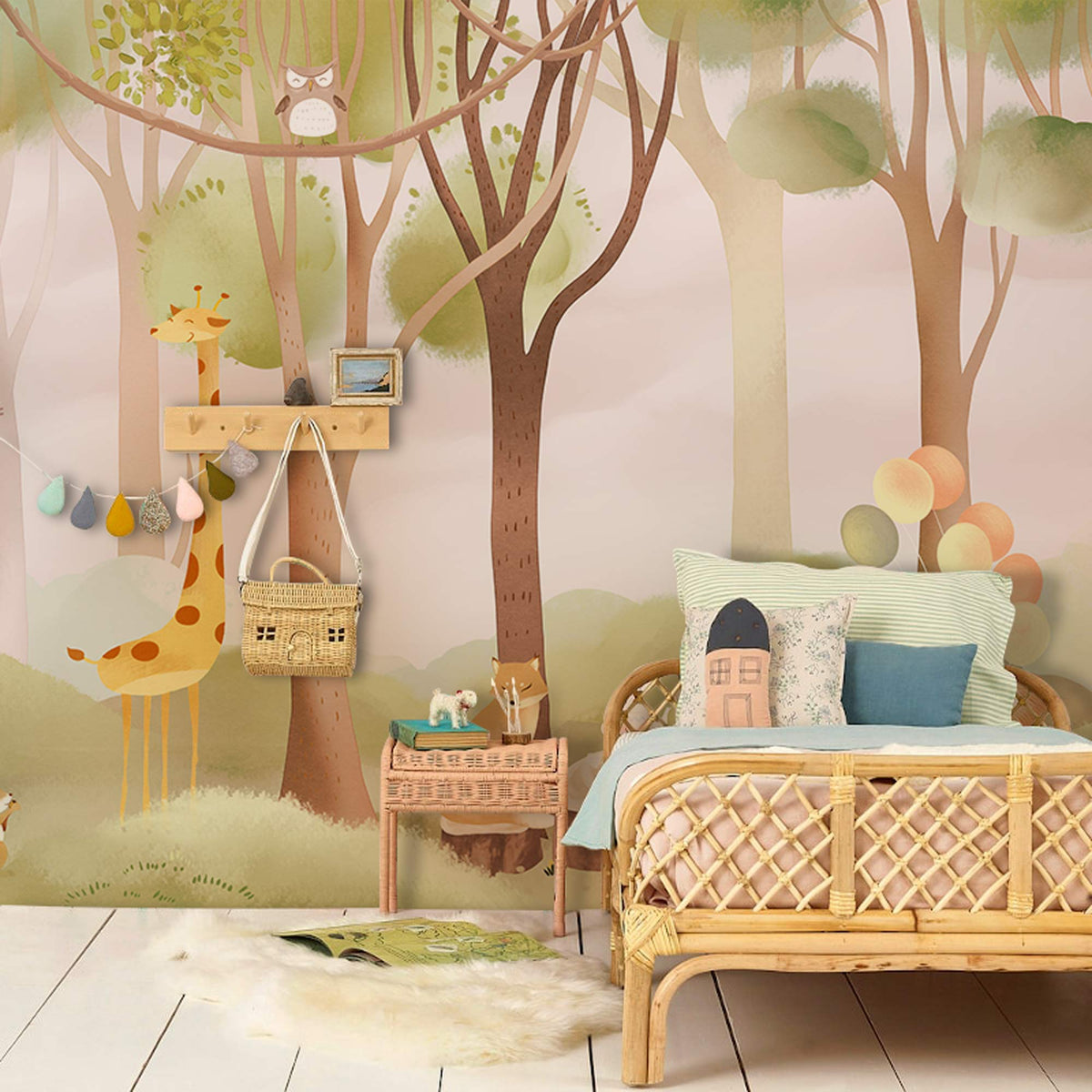 Children's Woodland Adventure Mural; rattan bed, pastel decor, wood flooring in nursery.
