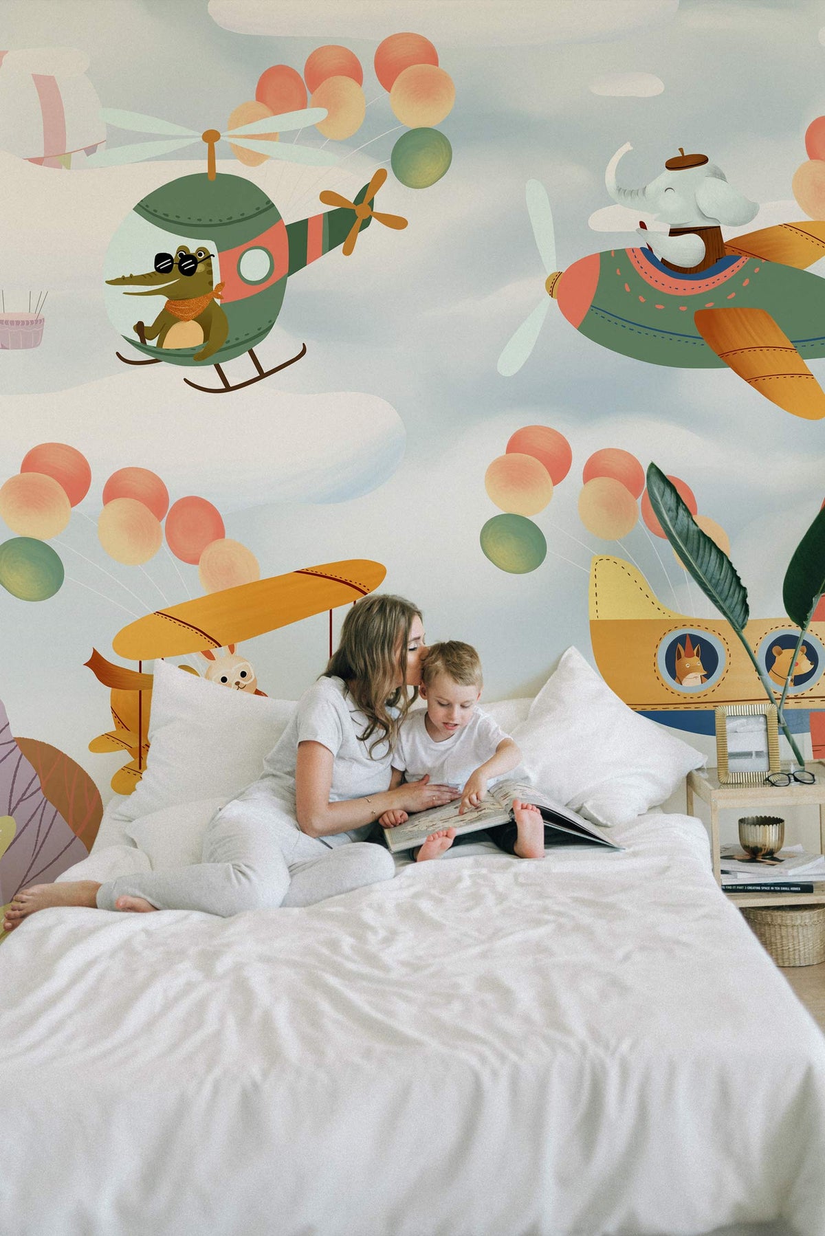 Whimsical Animal Pilots Mural Wallpaper with playful aeroplanes, balloons, and a cosy bed in bedroom.