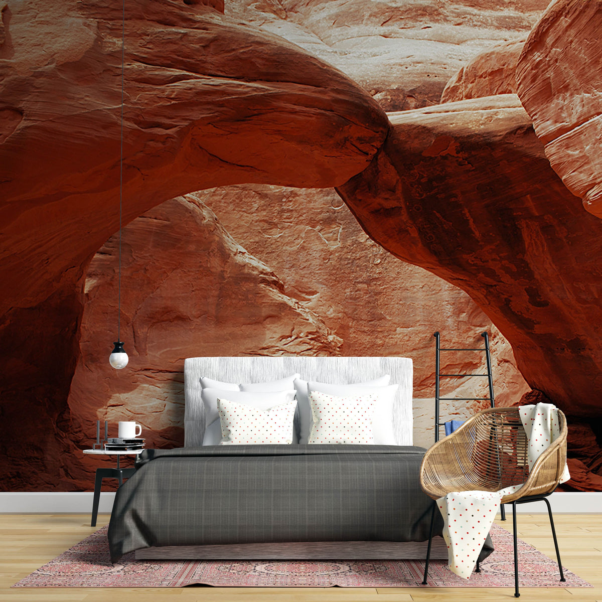 Earthy Canyon Red Stone wallpaper in desert-themed bedroom with modern grey bed and patterned rug.