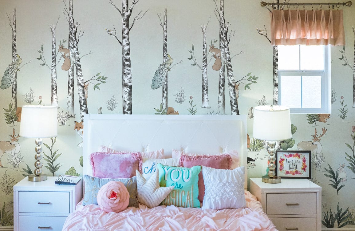 Enchanted Woodland Creatures mural in kids' bedroom, pastel decor, pink bedding, white furniture, lamps.