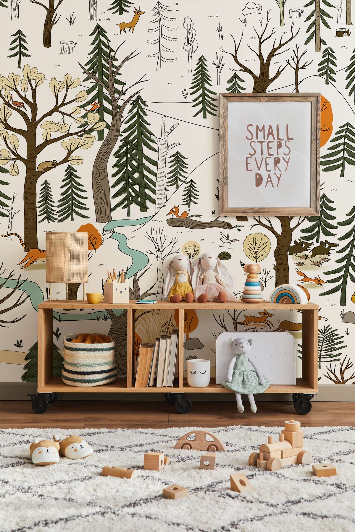 Children's room wallpaper with jungle theme, framed art, wooden furniture, plush toys, and patterned rug.