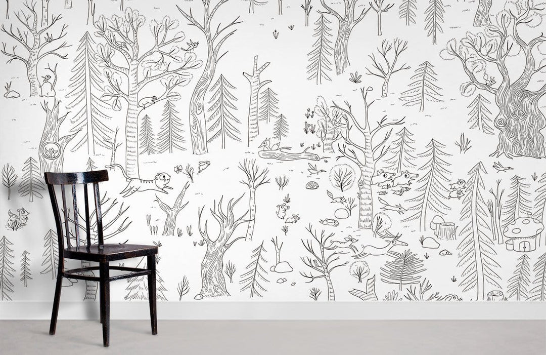 Black chair, grey flooring against Whimsical Woodland Adventure Forest Wallpaper Mural, hand-drawn design, wall art.