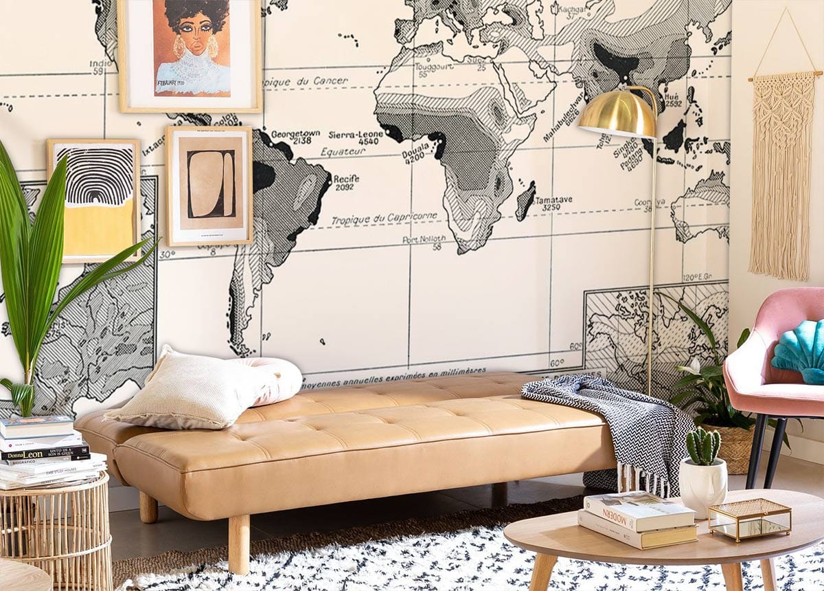 Cream leather sofa in stylish living room with Vintage Monochrome World Map Wallpaper, wooden flooring.