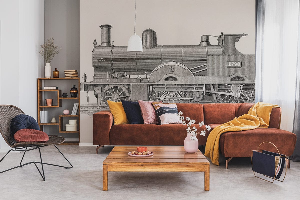 Victorian steam train mural, monochrome, brown vintage sofa, modern shelving unit, pendant light, concrete flooring.