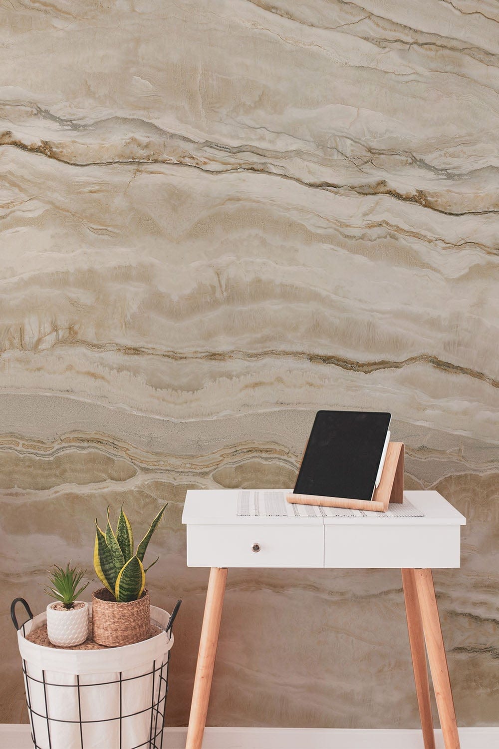 Elegant cream marble wallpaper mural with white desk, tablet, and potted plants in contemporary room.