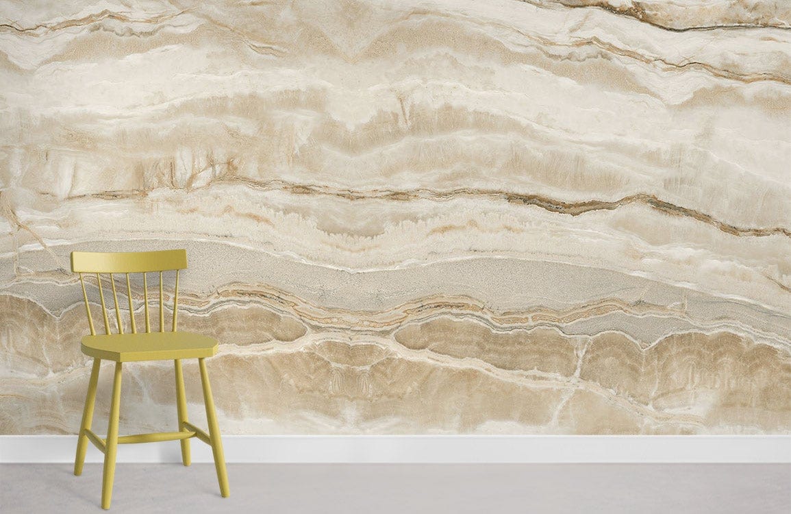 Elegant natural stone marble effect wallpaper mural, featuring a cream and beige pattern with green chair.