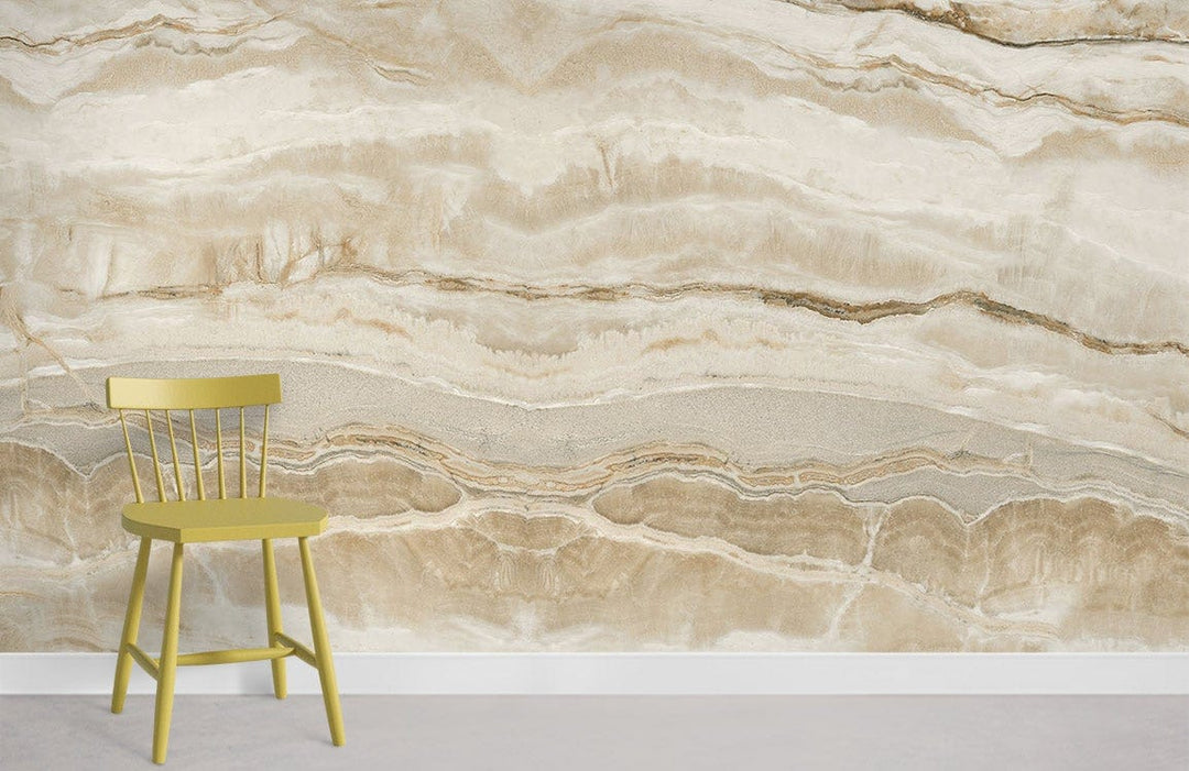 Elegant natural stone marble effect wallpaper mural, featuring a cream and beige pattern with green chair.