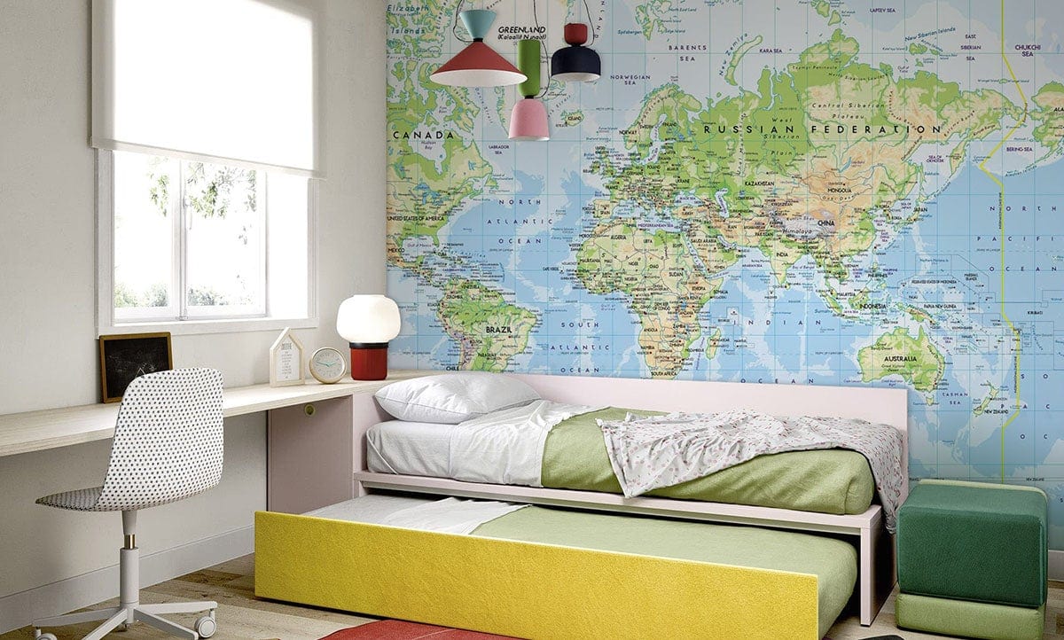 Children's room with colourful Vintage World Map Mural Wallpaper, minimalist desk, bed, and wooden flooring.