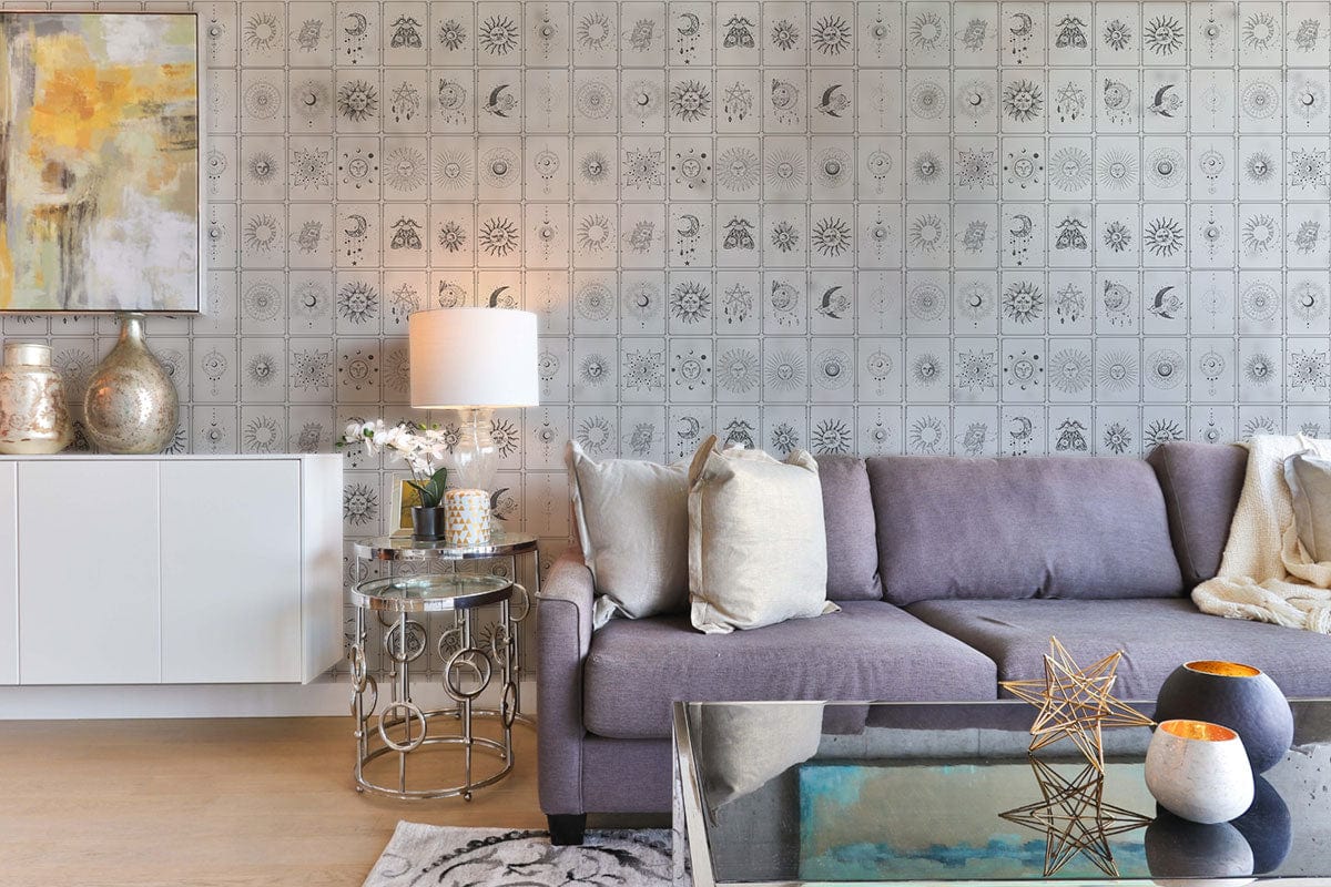 Grey geometric vintage tile wallpaper in elegant living room with modern grey sofa, glass coffee table.