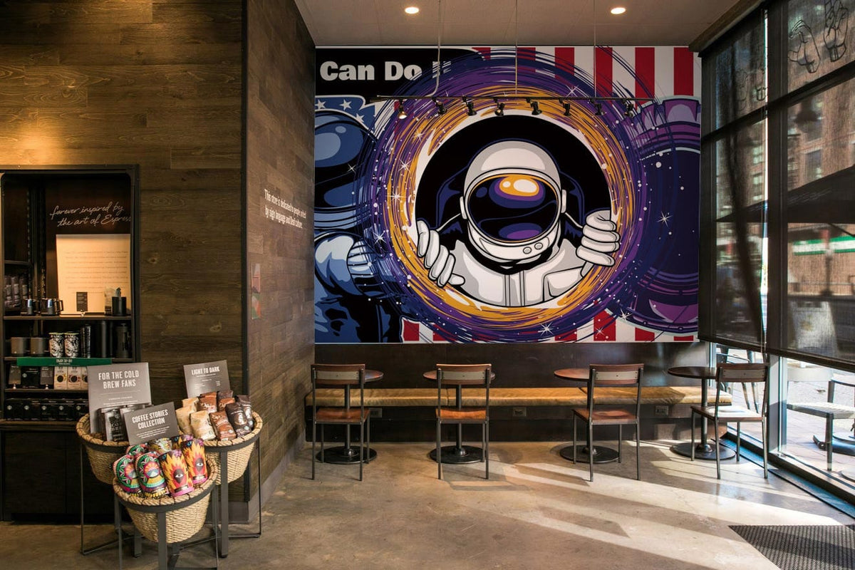 Retro Space Astronaut Mural Wallpaper with bold red and blue accents in modern café seating area.