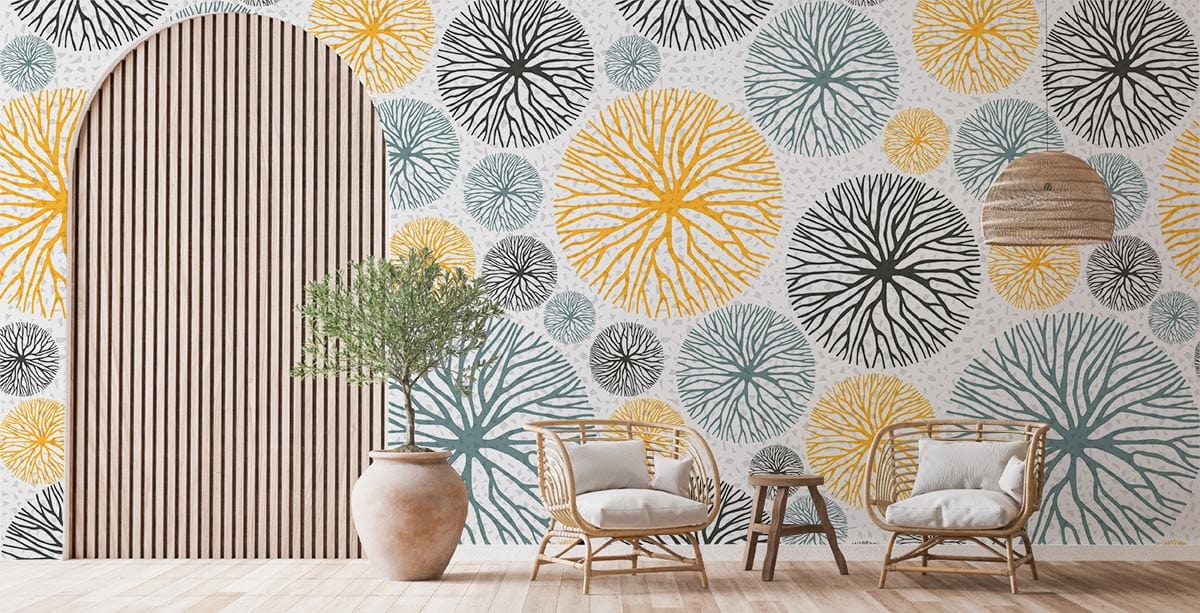 Modern Botanical Circles Wallpaper with yellow, blue, black patterns, rattan chairs, wooden flooring, potted plant.