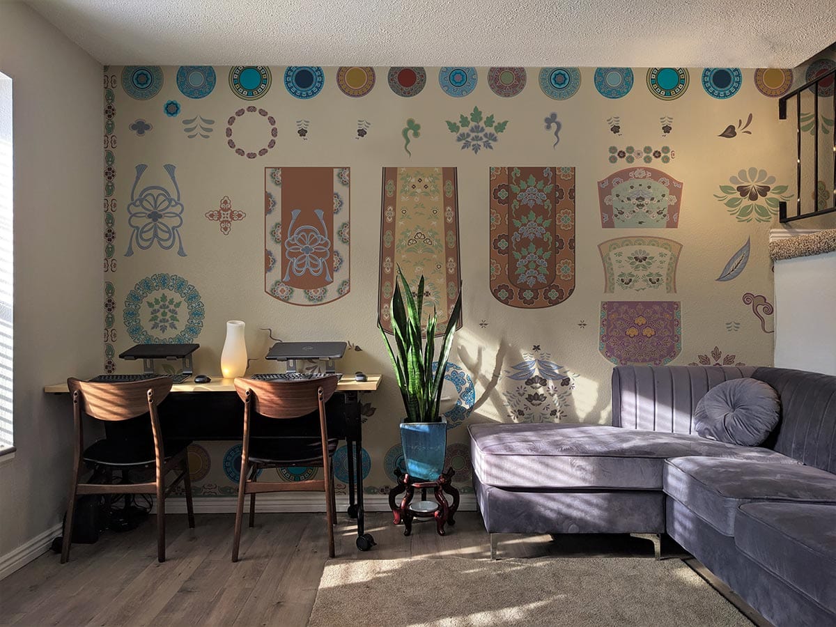 Vintage floral oriental wallpaper in elegant lounge, featuring grey sofa, wooden chairs, and stylish decor.