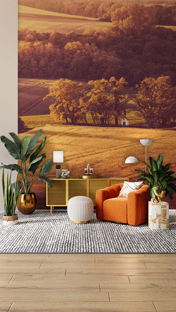 Sunset field mural with orange chair, light wood flooring, living room setting, warm earthy tones.