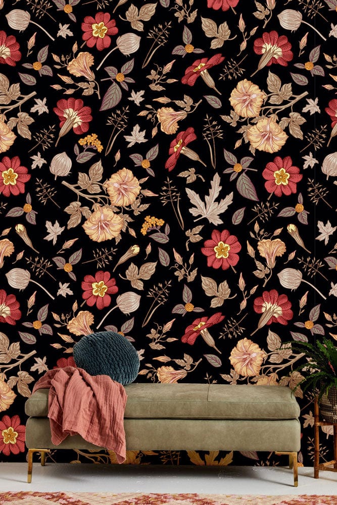 Vintage floral black mural wallpaper with red, gold blossoms; green sofa; vintage-style living room decor.