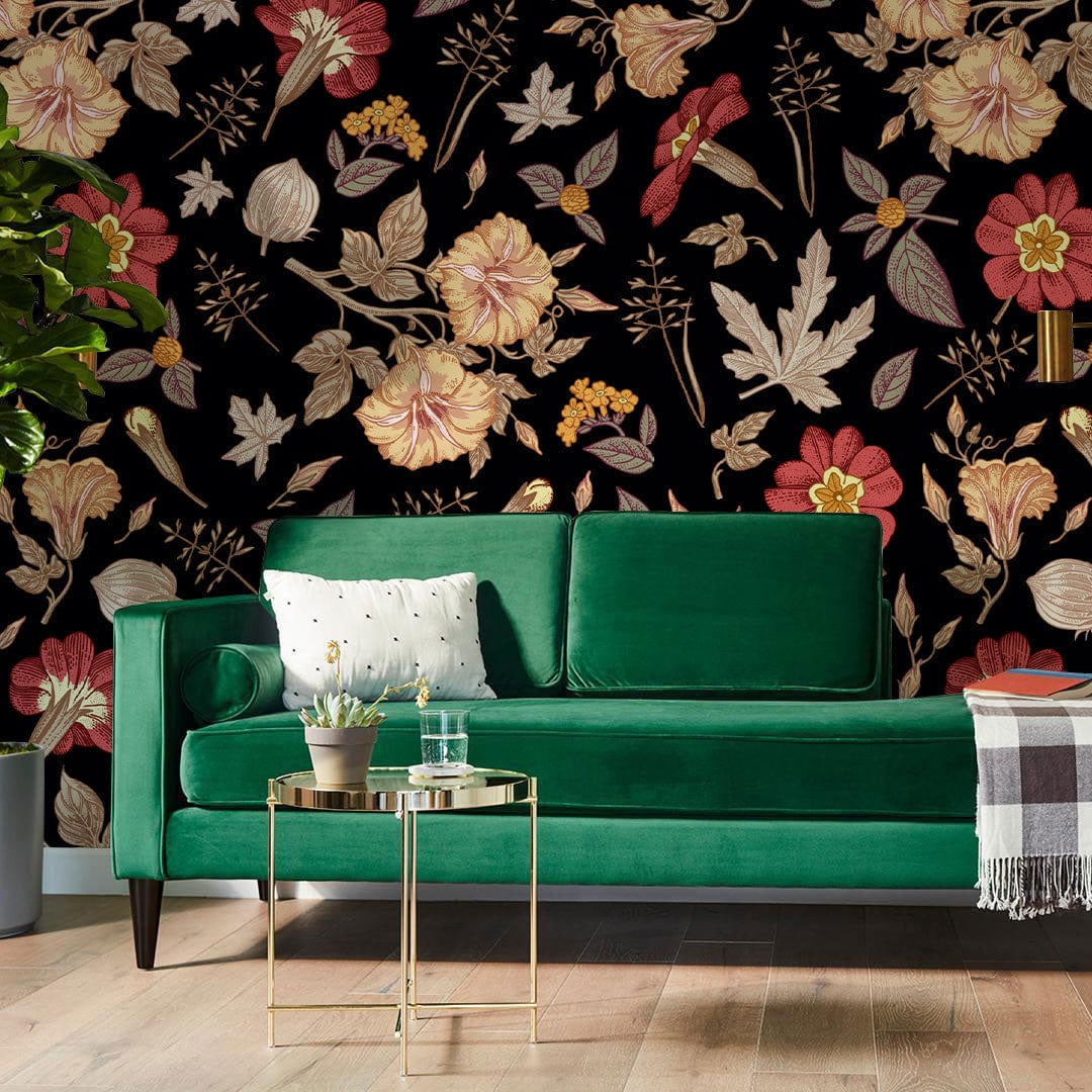Vintage floral wallpaper with red and gold blossoms, green sofa, wooden flooring in a living room.