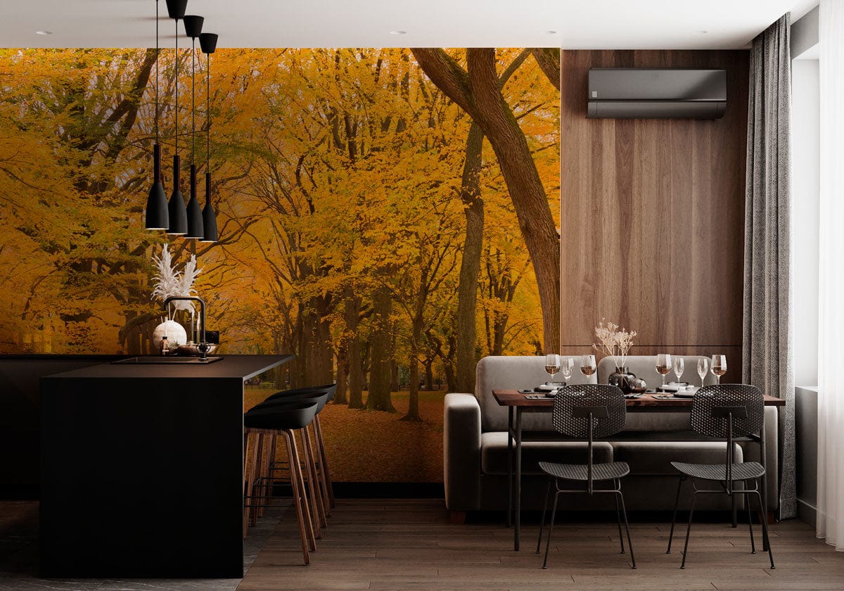 Golden Autumn forest mural with dark flooring, modern kitchen island, grey sofa, dining area in cosy interior.